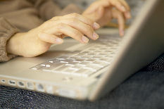 hands typing on a laptop