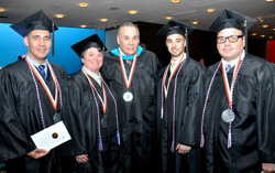 Red, white and blue tassels identify veterans and active members of the military graduating from the college. Seen here are Joseph Gutierrez, U.S. Navy, Catherine Liljequist, U.S.A.F, commencement speaker Robert Castelli ’95, a U.S. Army veteran who served in Vietnam, Nicholas Bronner, U.S.A.F. and Karl Roman.