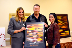 President Merodie Hancock presents 2013 Student Academic Conference Art competition winner Stephen O’Donnell Sr. with a framed copy of this work, “Pleasure.” Joining them is O’Donnell’s wife Sue Jean O’Donnell. (Photo/Empire State College)