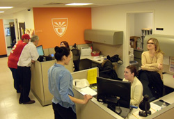 Faculty, students and staff gather at the college's Staten Island Office.