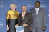 SUNY Chancellor Nancy L. Zimpher stands next to Dwight Anderson '98, '14 who is holding his Chancellor's Award for Student Excellence. Zimpher and Anderson were joined by the college's provost and vice president for academic affairs, Alfred Ntoko, at the 2015 award ceremony for all recipients held in Albany, N.Y./Photo Joe Putrock for SUNY