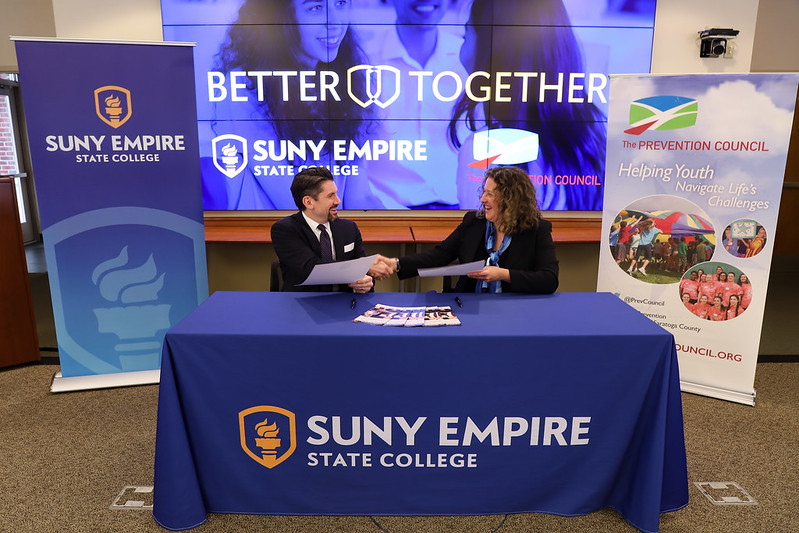 SUNY Empire State President Jim Malatras shaking hands with  Janine Stuchin, executive director of the Prevention Council.