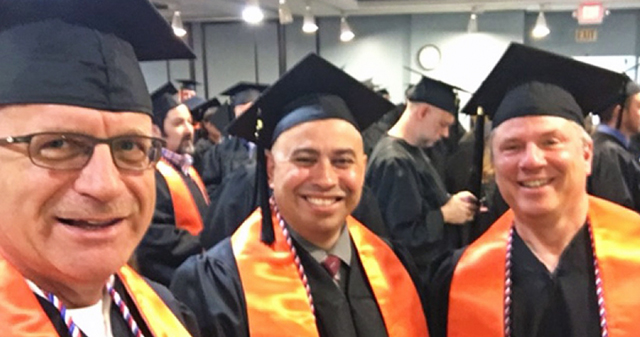 Image of Doug Sherman, left, with two other veterans, who also are members of SALUTE, at the 2017 commencement at Albany.