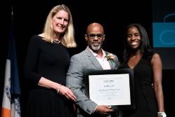 President Merodie Hancock stands next to Ted Bunch '94. Hancock and Bunch's his daughter, Maya Akiele Bunch, presented him with the 2016 Distinguished Alumni Award at the college's fifth annual celebration of black history. Photo/Marty Heitner '92