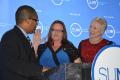 Joel Pierre-Louis, secretary of the university, swears in Lori Mould as the 2014-15 student trustee as Chancellor Zimpher looks on.