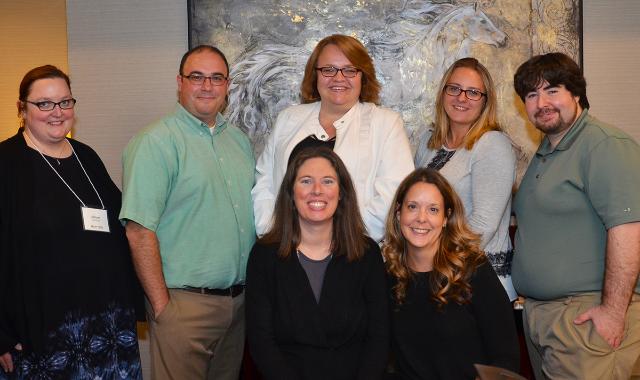 Standing left to right are Allison Moreland, Nathan Whitley-Grassi, Antonia Jokelova, Andrea Piazza-Victor and Educational Technologist Shaun Hoppel. Seated left to right are Jennifer Nettleton and Christine Paige.