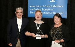 SUNY Empire student Patricia MacLeod, holding her ACT scholarship award, is supported by Frank Pagano, SUNY Fredonia ACT member, and Mary Caroline Powers, the college’s vice president for communications and government relations and liaison to ACT. Pagano organized the ACT award event. Photo/ Joe Putrock for SUNY