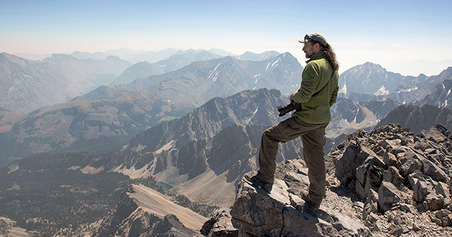 James Suits '12 standing atop Mount Borah, Idaho, while taking digital images of the 2017 solar eclipse.